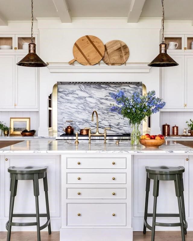 cutting board-pendant light sink-chairs-white kitchen cabinets