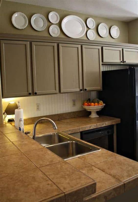 white plate collection on  sepia color cabinets wall