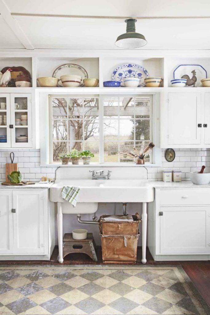 different plate or ceramics items collection above kitchen cabinet having white theme