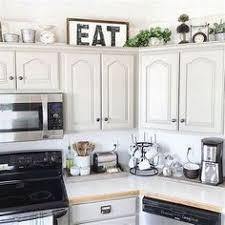 decorative sign above farm house kitchen cabinets