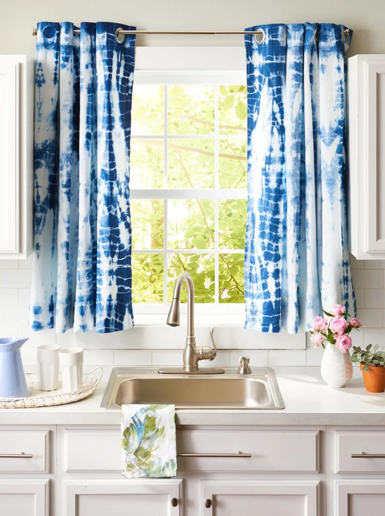 blue and white kitchen window curtain over sink