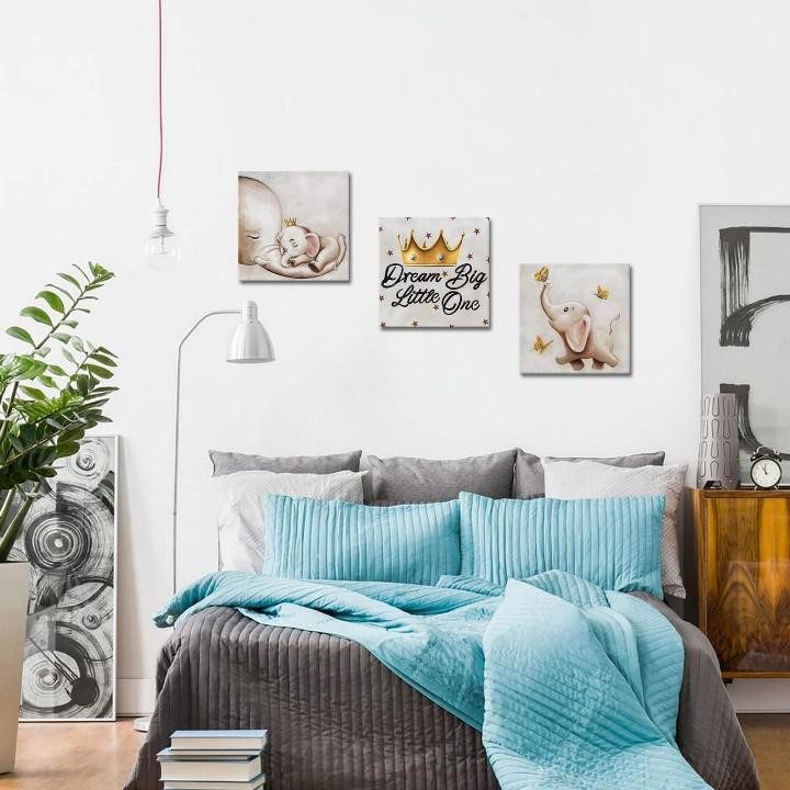 wall art in bedroom having blue contrast comforter and pillows