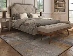 king size bed with grey rug and side table with lamp