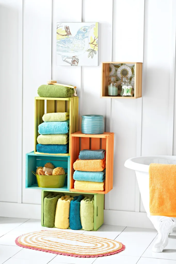 stack different color bathroom towels on shelves